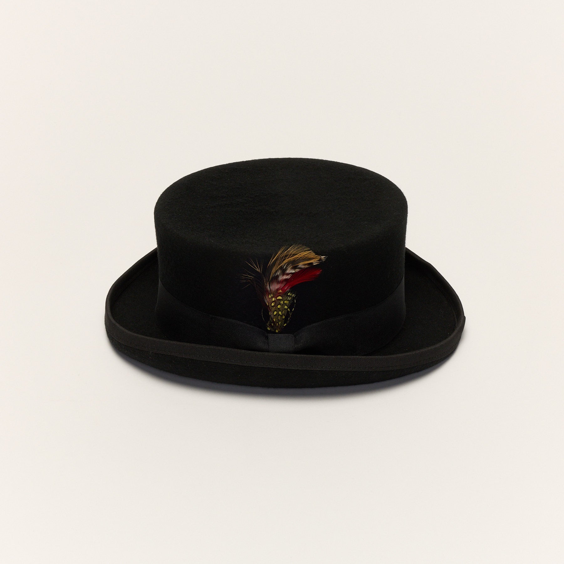 Black short crown top hat front view with removable feather and grosgrain ribbon