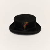 Black short crown top hat front view with removable feather and grosgrain ribbon